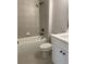 Clean, bright bathroom featuring tile flooring, a bathtub/shower combo, and modern fixtures at 2021 Shallowford Rd, Marietta, GA 30066