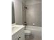 Well-lit bathroom featuring tile, a white vanity, and a shower and tub combo at 2021 Shallowford Rd, Marietta, GA 30066