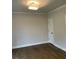 Neutral bedroom with hardwood floors, crown molding, and a closet with a paneled door at 2021 Shallowford Rd, Marietta, GA 30066