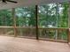 A relaxing wooden deck overlooks a serene view of lush trees and tranquil water at 2021 Shallowford Rd, Marietta, GA 30066