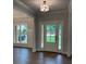 Welcoming entryway with hardwood floors, a stylish light fixture, and a bright, windowed front door at 2021 Shallowford Rd, Marietta, GA 30066