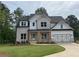 Beautiful two-story home featuring a brick and white exterior and a spacious two car garage at 2021 Shallowford Rd, Marietta, GA 30066