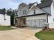 Beautiful two-story home featuring a brick and white exterior and a spacious two car garage at 2021 Shallowford Rd, Marietta, GA 30066