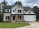 Charming two-story home featuring a brick and white facade, wood accents, and a well-manicured lawn at 2021 Shallowford Rd, Marietta, GA 30066