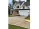 Modern two-story home with a white garage door, brick accents, and a spacious driveway at 2021 Shallowford Rd, Marietta, GA 30066