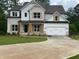 Beautiful two-story home featuring a brick and white exterior and a spacious two car garage at 2021 Shallowford Rd, Marietta, GA 30066