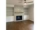 Cozy living room with a fireplace, built-in shelving, hardwood floors, and recessed lighting at 2021 Shallowford Rd, Marietta, GA 30066