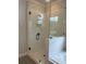 Modern bathroom shower featuring a glass door, white tile, and matte black hardware accents at 2021 Shallowford Rd, Marietta, GA 30066