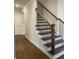 Beautiful staircase with hardwood steps and wrought iron balusters in a bright, open hallway at 2021 Shallowford Rd, Marietta, GA 30066