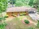 Aerial of home with mature trees, well-kept lawn, and convenient carport at 519 Beaver Ruin Nw Way, Lilburn, GA 30047