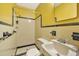 Vintage-style bathroom featuring a tiled shower, classic fixtures, and black and cream color scheme at 519 Beaver Ruin Nw Way, Lilburn, GA 30047