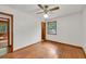 Bright bedroom with hardwood floors, ceiling fan, and natural light from the window at 519 Beaver Ruin Nw Way, Lilburn, GA 30047