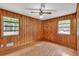Bedroom featuring two windows that provide natural light and a view of the surrounding trees at 519 Beaver Ruin Nw Way, Lilburn, GA 30047