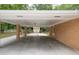 Spacious carport area with brick pillars and a view of the manicured backyard at 519 Beaver Ruin Nw Way, Lilburn, GA 30047