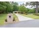Inviting home with long driveway, brick mailbox and lush landscaping creating a welcoming entrance at 519 Beaver Ruin Nw Way, Lilburn, GA 30047