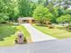 Inviting exterior view of this brick home, showing the circular driveway and mature trees at 519 Beaver Ruin Nw Way, Lilburn, GA 30047