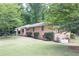 Charming brick home with well-maintained lawn and landscaping, nestled among mature trees at 519 Beaver Ruin Nw Way, Lilburn, GA 30047