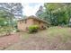 View of the brick house exterior and manicured grounds, showcasing its serene backyard setting at 519 Beaver Ruin Nw Way, Lilburn, GA 30047