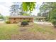A brick home featuring an attached covered carport and landscaped surroundings at 519 Beaver Ruin Nw Way, Lilburn, GA 30047
