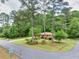Exterior of brick home featuring a corner lot with mature trees and landscaped surroundings at 519 Beaver Ruin Nw Way, Lilburn, GA 30047
