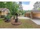 Property featuring a detached outbuilding, covered parking, and lush greenery at 519 Beaver Ruin Nw Way, Lilburn, GA 30047