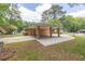 Property featuring covered parking, mature trees, and a well-maintained lawn at 519 Beaver Ruin Nw Way, Lilburn, GA 30047