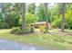 Charming brick home with a lush green lawn and mature trees creating a serene, park-like setting at 519 Beaver Ruin Nw Way, Lilburn, GA 30047