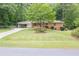 Beautiful single-story brick home featuring a covered carport and a well-manicured front lawn at 519 Beaver Ruin Nw Way, Lilburn, GA 30047