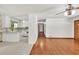 Open concept: a view of kitchen leading to the living room featuring hardwood floors and white trim at 519 Beaver Ruin Nw Way, Lilburn, GA 30047