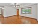 Bright living room featuring a large window with a view and original hardwood floors at 519 Beaver Ruin Nw Way, Lilburn, GA 30047
