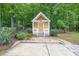 Charming outbuilding with a white picket fence, lush landscaping, and a concrete walkway at 519 Beaver Ruin Nw Way, Lilburn, GA 30047