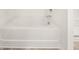 An angled bathtub alcove features laminate flooring at 1473 Autumn Wind Dr, Dacula, GA 30019