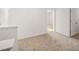 Bright hallway with neutral carpet, white walls, and plenty of natural light at 1473 Autumn Wind Dr, Dacula, GA 30019