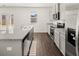 Modern kitchen showcases granite countertops, stainless steel appliances, and wood flooring at 1473 Autumn Wind Dr, Dacula, GA 30019