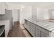 Stylish kitchen boasts granite countertops, stainless steel appliances, ample cabinet space, and wood flooring at 1473 Autumn Wind Dr, Dacula, GA 30019