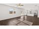 Large living area flows into kitchen, featuring wood floors, modern lighting, and an open floor plan at 1473 Autumn Wind Dr, Dacula, GA 30019