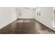 Large living room with lots of natural light, wood floors, and a ceiling fan at 1473 Autumn Wind Dr, Dacula, GA 30019