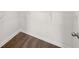 A simple walk-in closet includes wood-look flooring and metal shelving at 1473 Autumn Wind Dr, Dacula, GA 30019