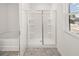 New bathroom with glass-enclosed shower, separate tub, and window with blinds at 1483 Autumn Wind Dr, Dacula, GA 30019
