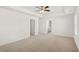 Bright bedroom showcasing neutral carpet, ceiling fan, and ensuite bathroom access at 1483 Autumn Wind Dr, Dacula, GA 30019