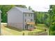 Exterior view of a two-story home featuring a well-maintained lawn and a small wooden deck at 1483 Autumn Wind Dr, Dacula, GA 30019