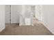 Hallway landing featuring neutral carpet, white walls and trim, and staircase access at 1483 Autumn Wind Dr, Dacula, GA 30019