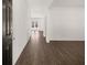 Spacious hallway with dark wood-look floors leading to multiple rooms bathed in light at 1483 Autumn Wind Dr, Dacula, GA 30019