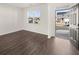 Inviting living room featuring hardwood floors and a bright view from the front door and large window at 1483 Autumn Wind Dr, Dacula, GA 30019
