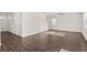 Open-concept living room boasts hardwood floors, natural light, and seamless flow to other living areas at 1483 Autumn Wind Dr, Dacula, GA 30019