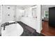 Elegant bathroom featuring dual sinks, sleek countertops, glass enclosed shower, and a standalone tub at 2324 Oakview Ne Rd, Atlanta, GA 30317