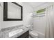 Well-lit bathroom boasts granite counters and tiled shower/bath combination at 2324 Oakview Ne Rd, Atlanta, GA 30317