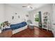 Cozy bedroom includes wood floors, natural light, and decorative shelving at 2324 Oakview Ne Rd, Atlanta, GA 30317