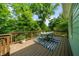 Relaxing deck features an outdoor dining table with view of the surrounding trees at 2324 Oakview Ne Rd, Atlanta, GA 30317
