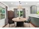 Dining area featuring a round table, stylish chairs, and natural light from the window at 2324 Oakview Ne Rd, Atlanta, GA 30317
